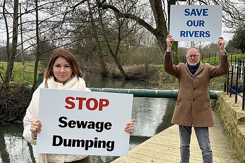 Liberal Democrats hold signs saying Stop Dumping Sewage and Save our Rivers