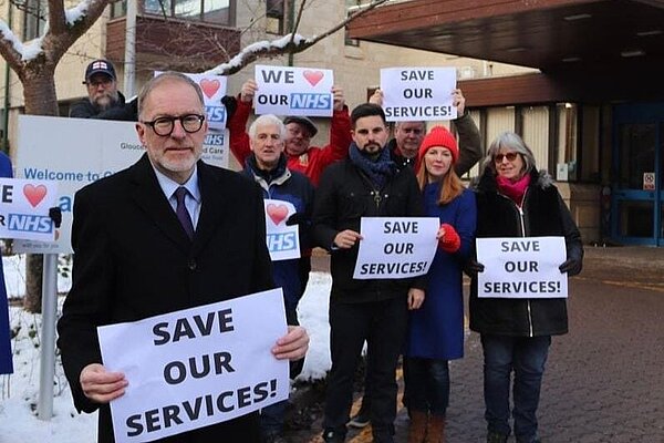 Paul and the Cotswolds Liberal Democrat Team hold "Save Our Services" signs
