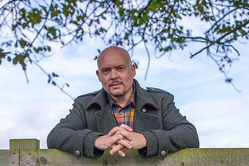 Cameron Thomas in a field next to Tewkesbury Abbey