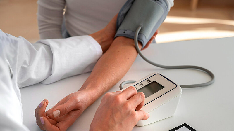 Pharmacist conducting a blood pressure check