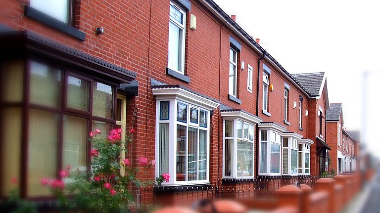Supported by Cameron Thomas MP and County Councillor Dr Kate Usmar - Tewkesbury East. A row of houses.